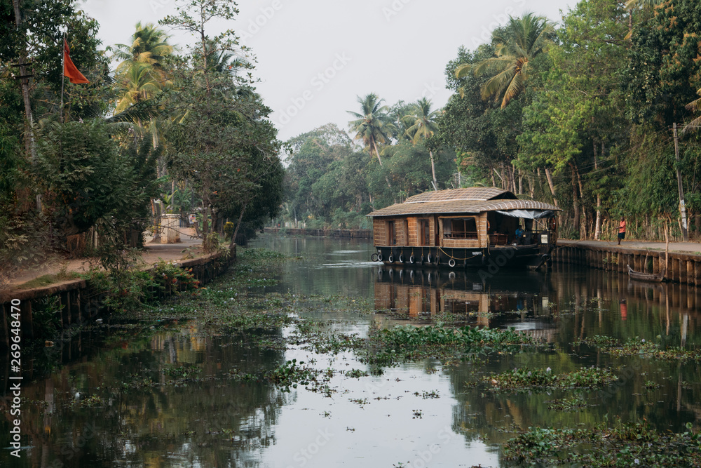 Traditional  indian houseboat floating in backwaters of Kerala