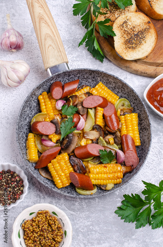 Slices of fried vegetables with sausages