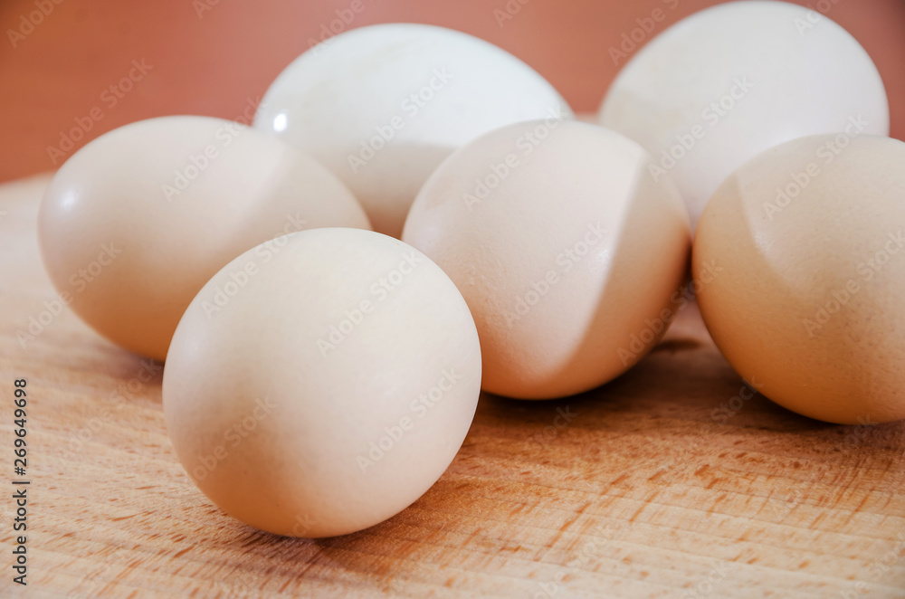 Chicken eggs on a wooden background. Close-up. Chicken eggs on a wooden background. Close-up.
