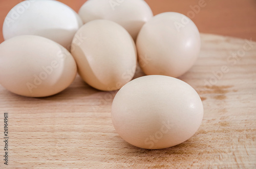 Chicken eggs on a wooden background. Close-up.