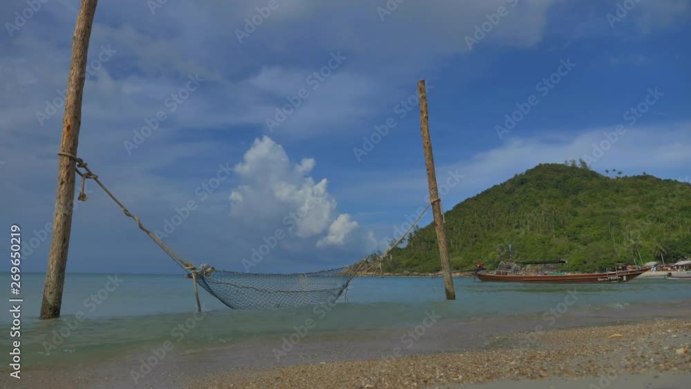 Empty tropical sand beach, long tail taxi boats slowly moving on water, static shot with no color grading Empty tropical sand beach, long tail taxi boats slowly moving on water, static shot with no color grading