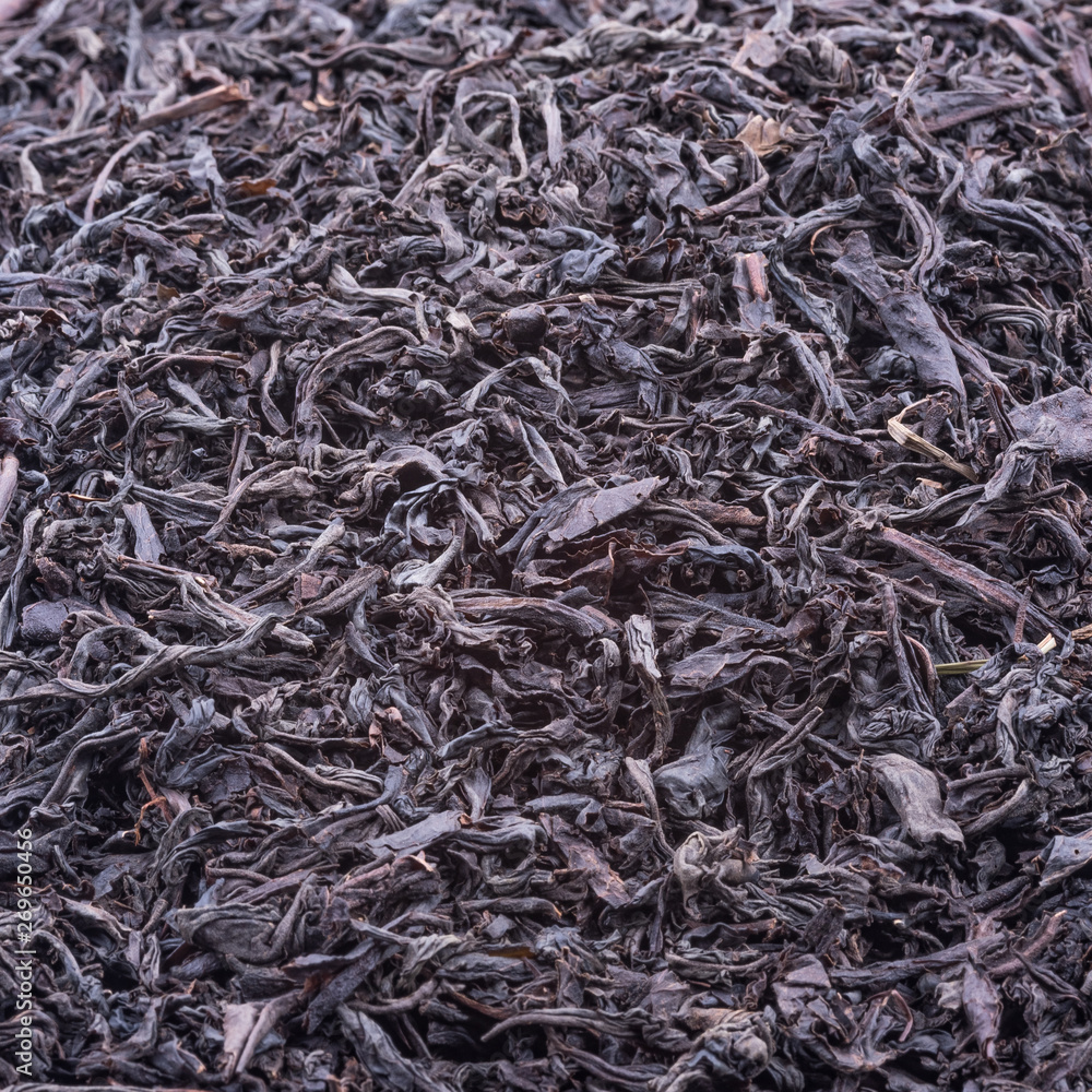 Background of dried tea leaves of dark color. Macro. Background of dried tea leaves of dark color. Macro.