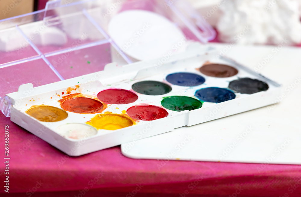 Multi-colored paints are on the table Multi-colored paints are on the table