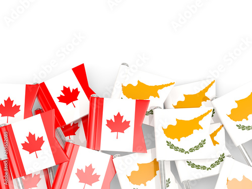 Pins with flags of Canada and cyprus isolated on white.
