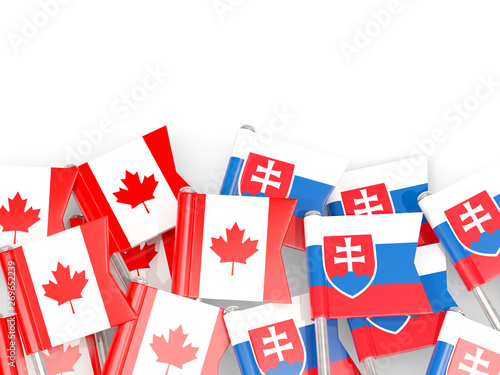 Pins with flags of Canada and slovakia isolated on white.