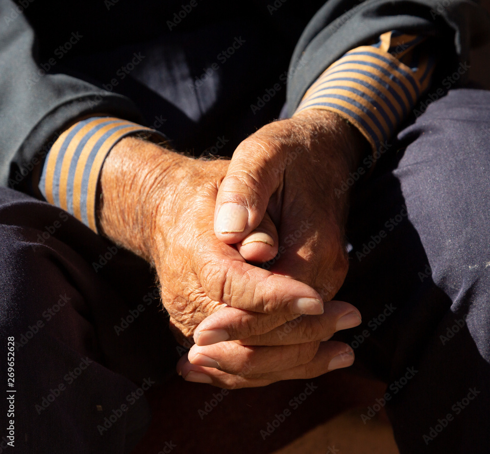Man hands are folded in peaceful reflection