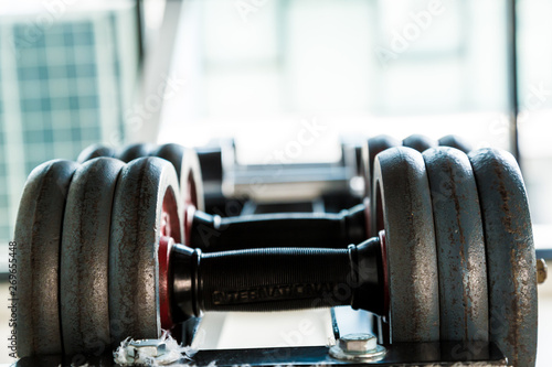 Iron dumbbell on shelf in fitness gym