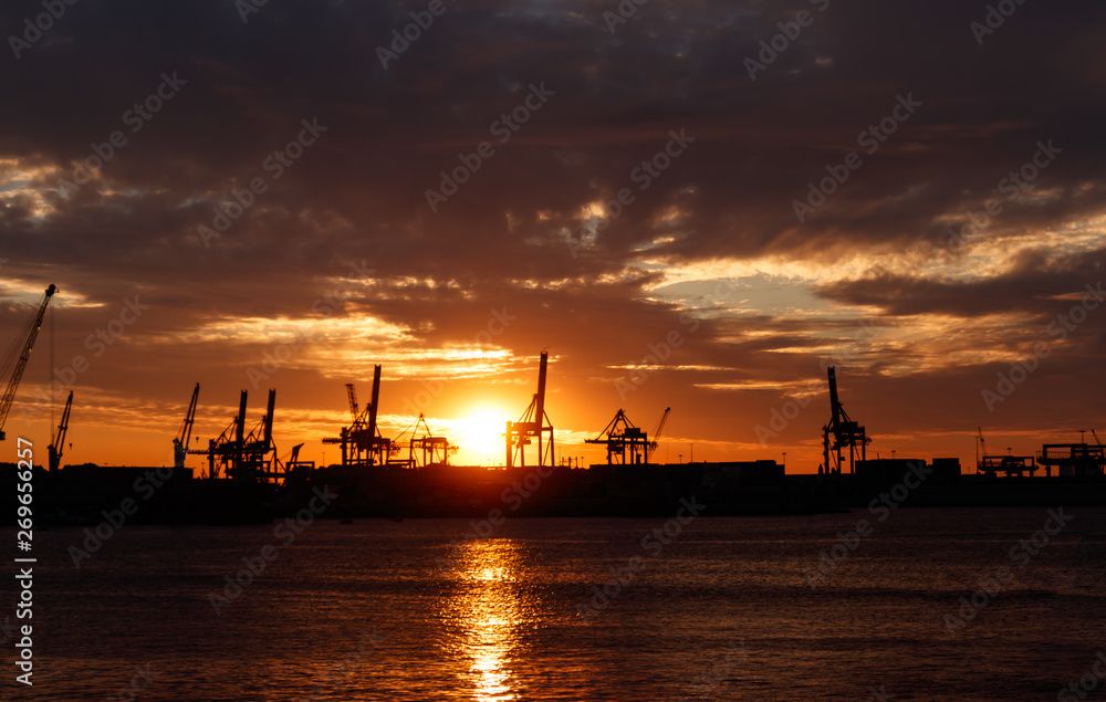 cargo cranes at sunset