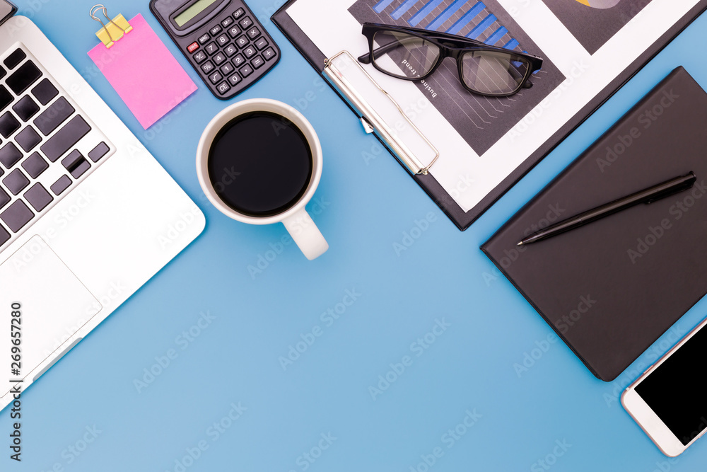 flat lay Office desk table of modern workplace with laptop on blue table, top view laptop background and copy space on blue background, blue desk office with laptop, smartphone and other work supplies flat lay Office desk table of modern workplace with laptop on blue table, top view laptop background and copy space on blue background, blue desk office with laptop, smartphone and other work supplies