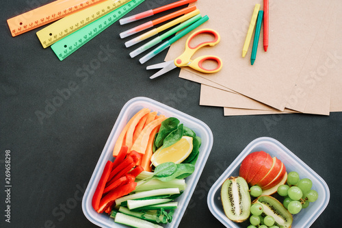 School supplies and Lunch box with vegetable sticks. Back to school concept