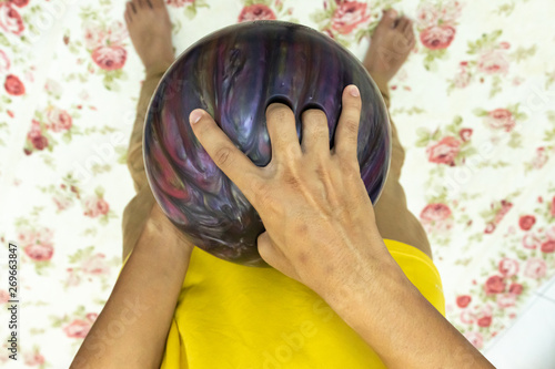 Point of view hand holding bowling ball
