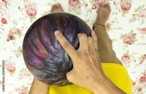 Point of view hand holding bowling ball