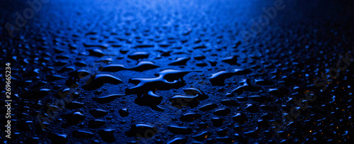 Wet asphalt, night scene of an empty street with a little reflection in the water, the night after the rain. Abstract dark neon background with a wet surface, reflection, neon, glare, blurred bokeh. photo