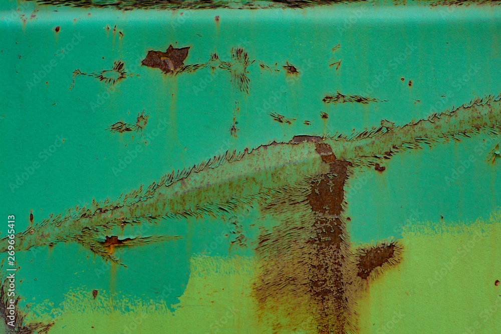 Old metal surface with dents painted green with wide stripes of rust Old metal surface with dents painted green with wide stripes of rust