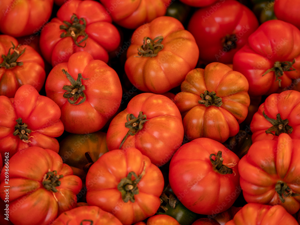 Close up view on fresh meat tomatoes at a market Close up view on fresh meat tomatoes at a market