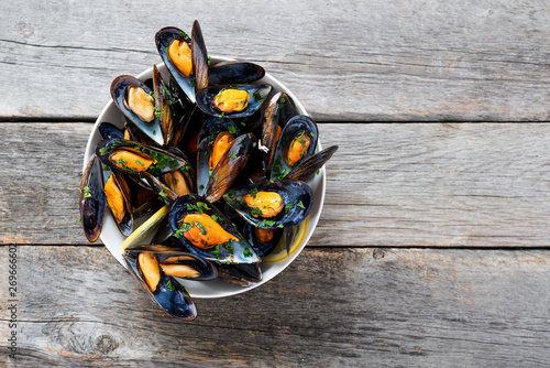 Delicious seafood mussels with  parsley sauce and lemon. photo