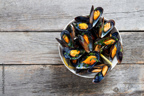 Delicious seafood mussels with parsley sauce and lemon.