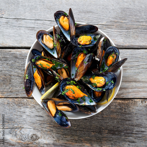 Delicious seafood mussels with  parsley sauce and lemon. photo