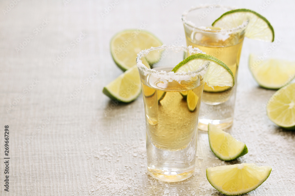 Tequila shots with sliced lime Tequila shots with sliced lime