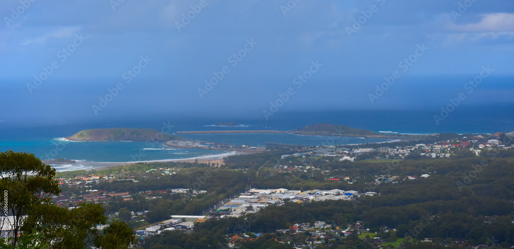 Fototapeta premium View of Coffs Harbour from Forest Sky Pier, which is a lookout pier with sweeping views on a cloudy day.