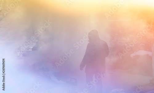 Man silhouette in colorful smoke 
