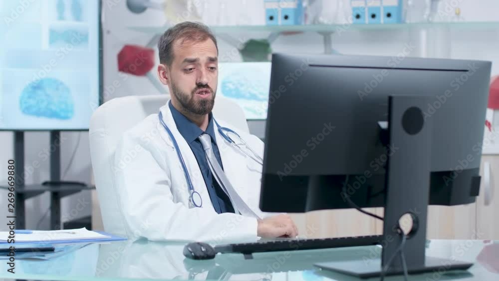 Scientist having a video call in his modern research center with 3D brain simulations running in the background in monitors Scientist having a video call in his modern research center with 3D brain simulations running in the background in monitors