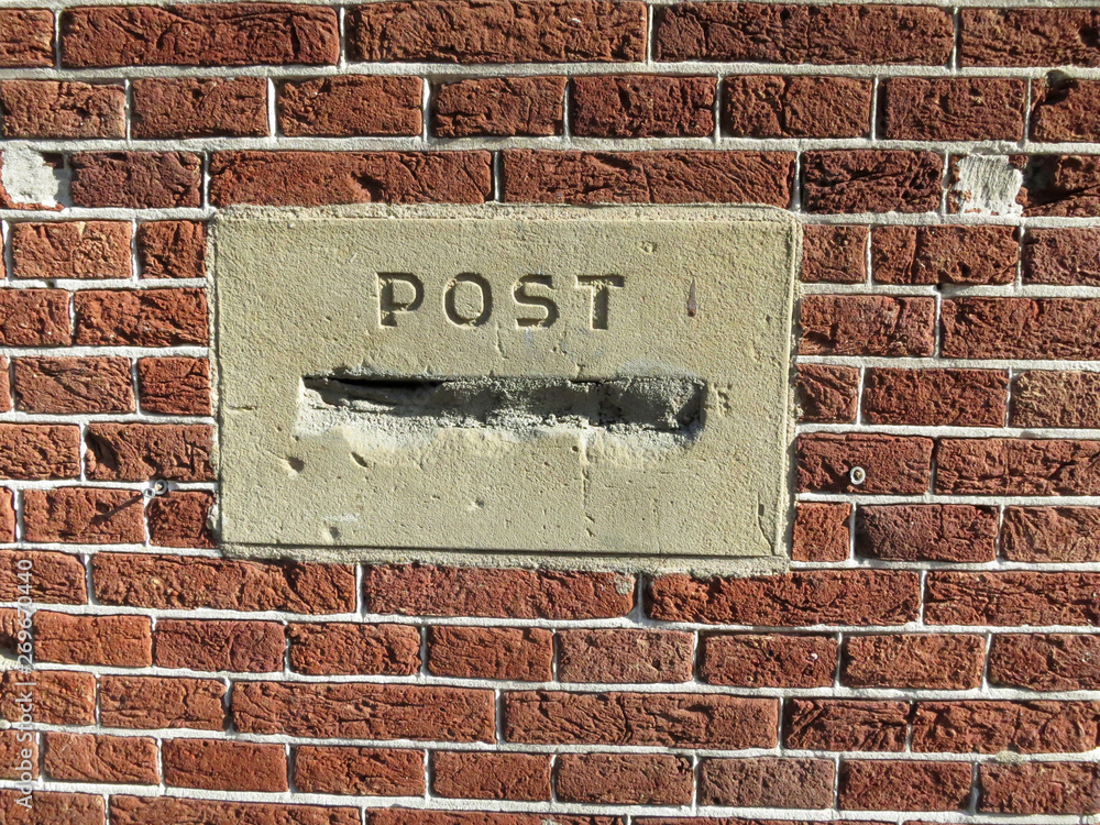 post mortem, a post box or mailbox stopped up with cement in a red brick wall post mortem, a post box or mailbox stopped up with cement in a red brick wall