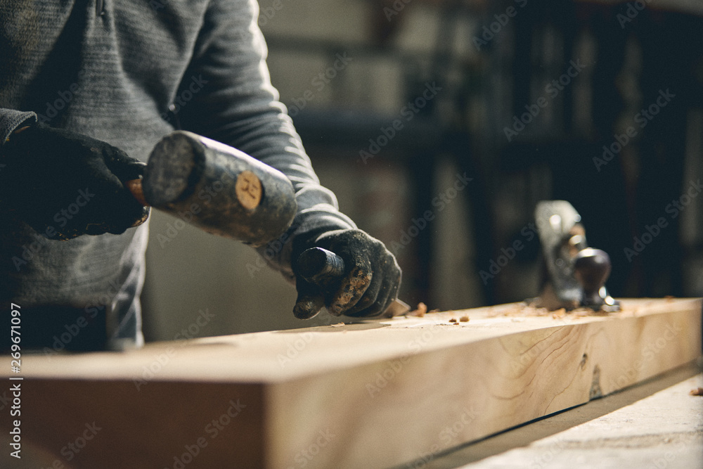Carpenter at work on wood table with tools