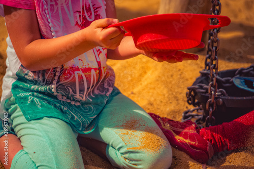 Child is playing in the sand