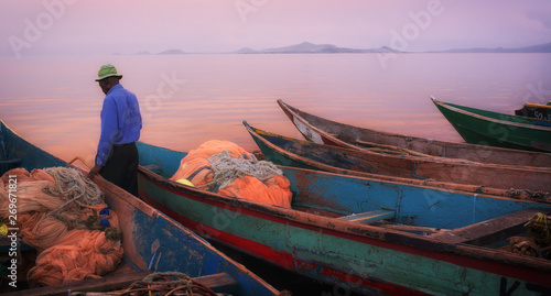 Colorful scenic sunset with fishing boats in the foreground on Mfangano Island, Lake Victoria, Kenya