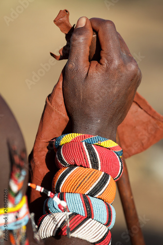 Close-up of the arm of a Samburu warrior in Kenya with colorful traditional bracelets and wristbands