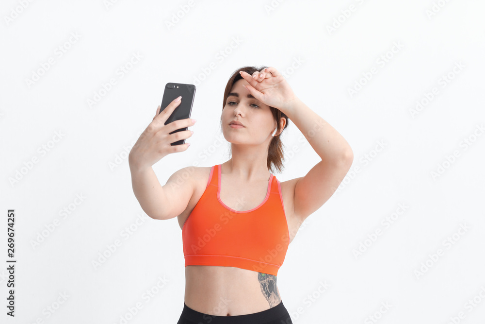 Young brunette woman making selfie during workout. Sport activity for weight loss. Young brunette woman making selfie during workout. Sport activity for weight loss.