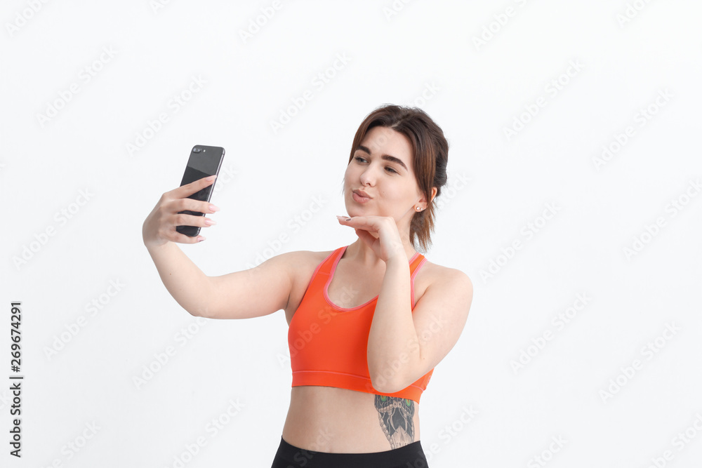 Young brunette woman making selfie during workout. Sport activity for weight loss. Young brunette woman making selfie during workout. Sport activity for weight loss.