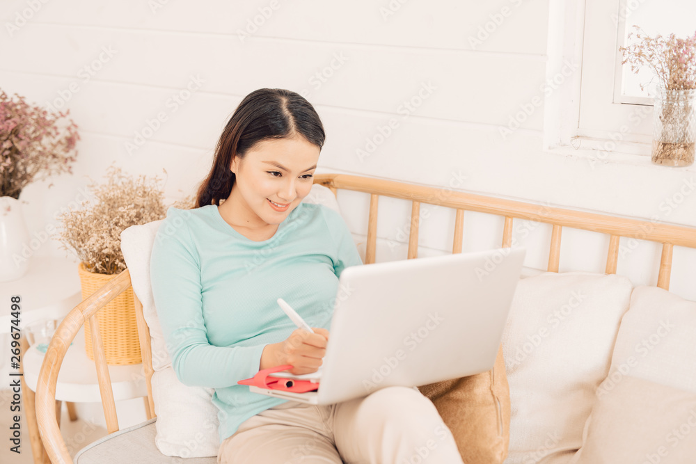 Woman freelancer female hands with pen writing on notebook at home or office Woman freelancer female hands with pen writing on notebook at home or office