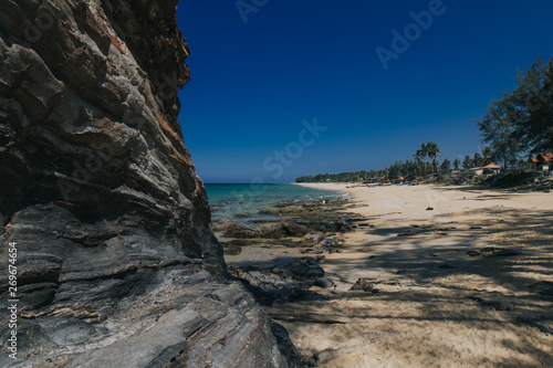 Beautiful tropical island beach scenery with palm trees,nature rock formation and blue sky background.