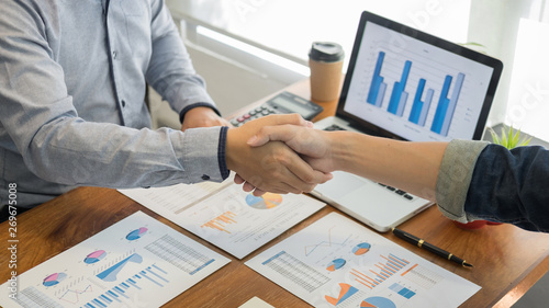 Two confident business man shaking hands during a meeting in the office, success, dealing, greeting and partner concept.