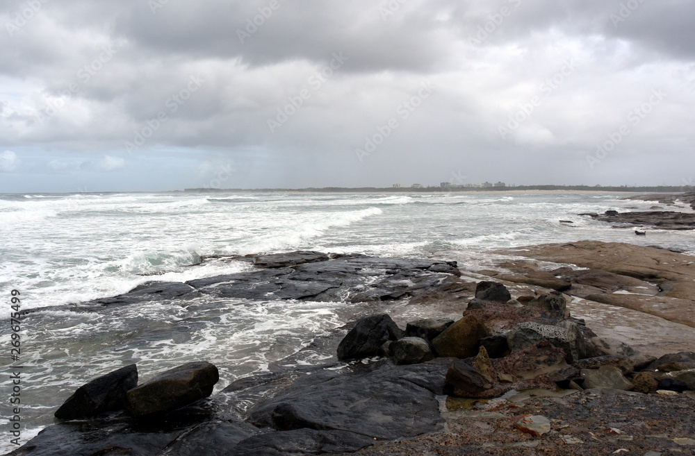 View of Bribie sandy Island from Kings beach on a stormy cloudy day (Caloundra, Sunshine Coast, Queensland, Australia).