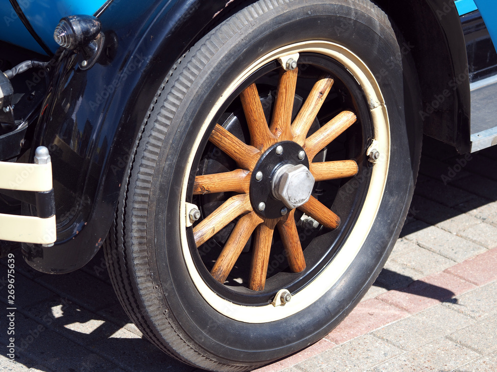 The wheel of an old car with wooden spoke of the early twentieth century