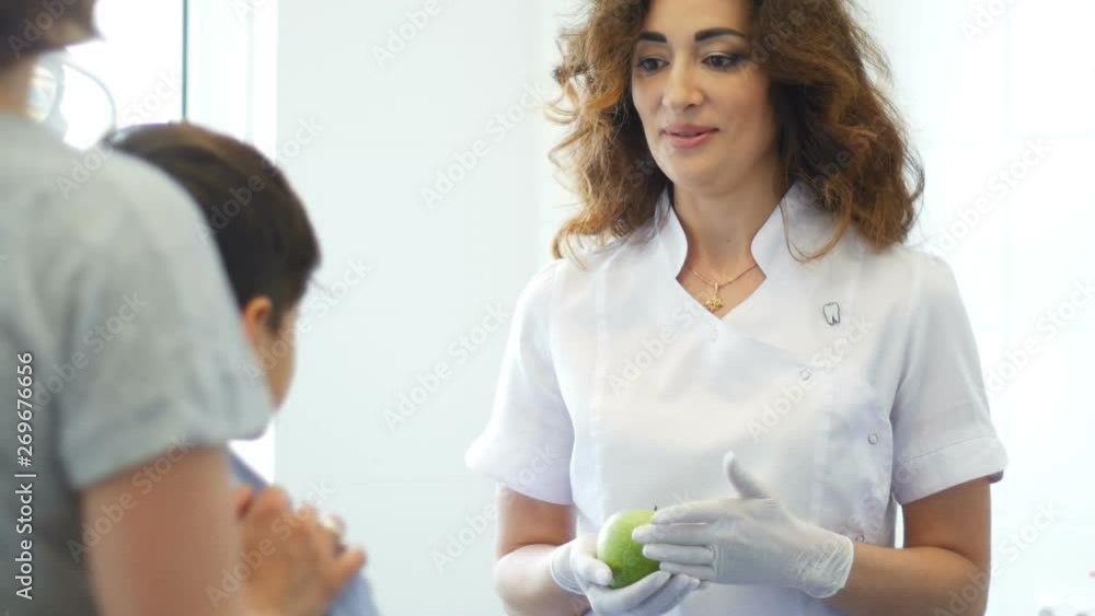 Dentist woman holding an apple Dentist woman holding an apple