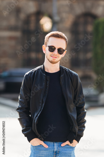 stylish man in leather jacket and hands in pockets. City style.