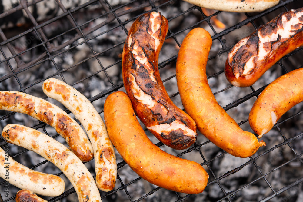 Fototapeta premium sausages or sausages on the grill. cooking sausages in the open air.