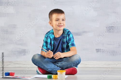 Cute boy painting picture o...