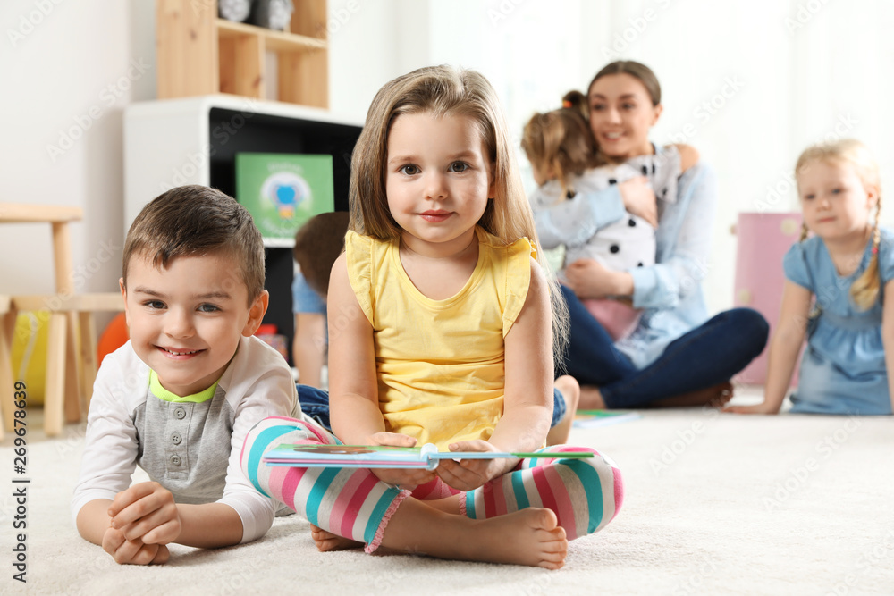 Cute little children with book indoors, space for text. Learning and playing Cute little children with book indoors, space for text. Learning and playing