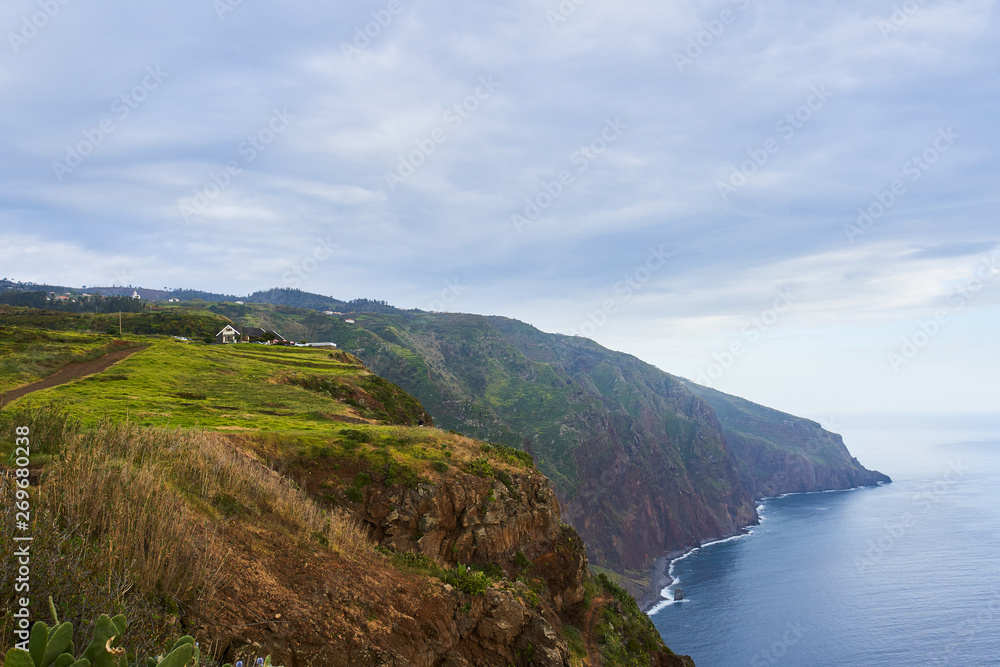 Beautiful scenery in Ponta do Pargo, Madeira with cliff, ocean and blue sky in a rainy day