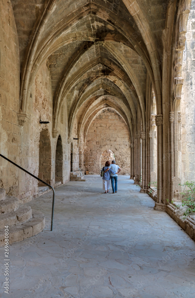 two tourists  visiting Bellapais Abbey in Cyprus