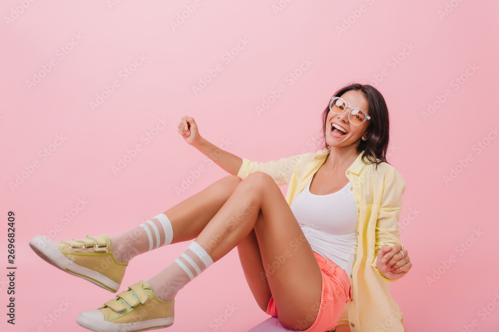 Fashion, woman and sitting on floor in studio with happiness and