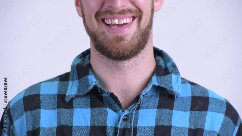 Smile of bearded hipster man against white background Smile of bearded hipster man against white background