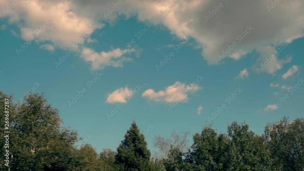 Fast moving scenery at beautiful landscape, sky, clouds and forest from the window. Travelling by car, train or bus at sunny day. Slow motion. Fast moving scenery at beautiful landscape, sky, clouds and forest from the window. Travelling by car, train or bus at sunny day. Slow motion.