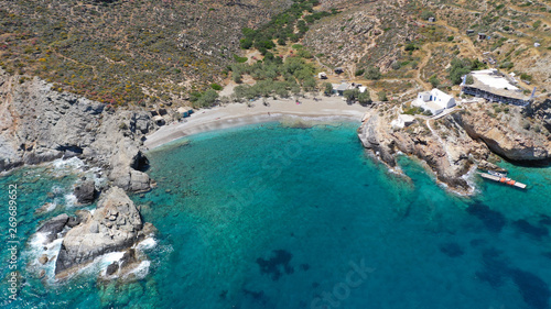 Aerial drone photo of secluded deep turquoise beach of Agios Nikolaos with crystal clear sea and sandy sea shore, Folegandros island, Cyclades, Greece