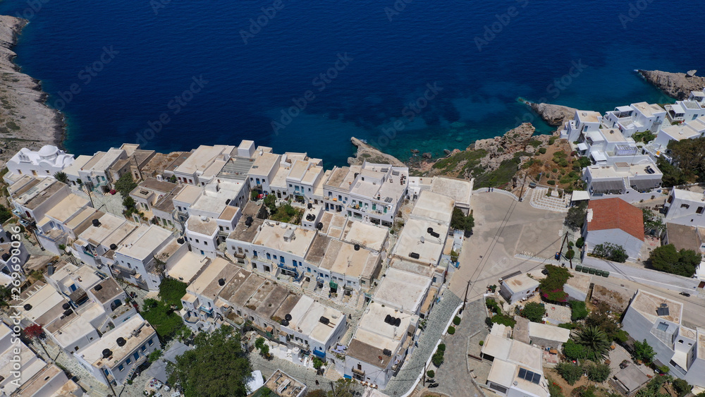 Aerial drone photo of iconic and picturesque main village (chora) of Folegandros island featuring castle and built on top of steep hill overlooking the Aegean blue sea, Cyclades, Greece